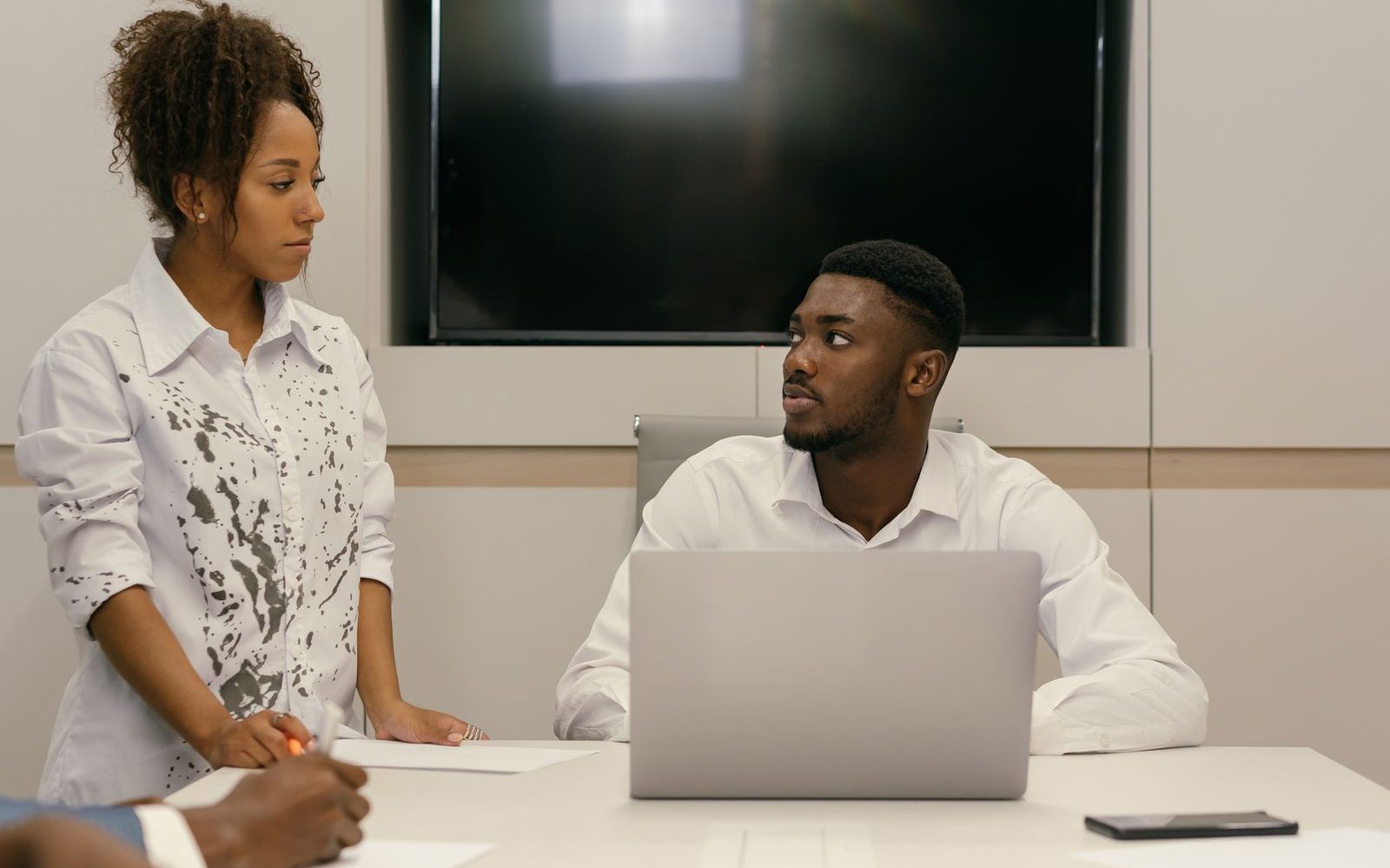 Two colleagues reviewing business accounts together at a desk