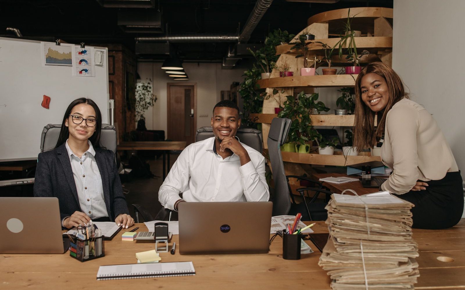An African business team meeting around laptops in a modern office