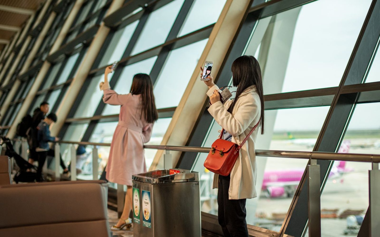 A professional sending money internationally from their phone in a modern office